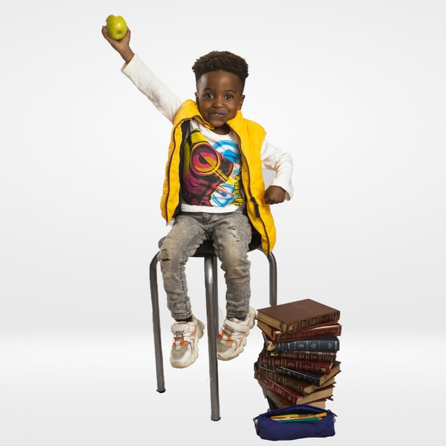 Toddler sitrigbon a chair at a school photoshoot