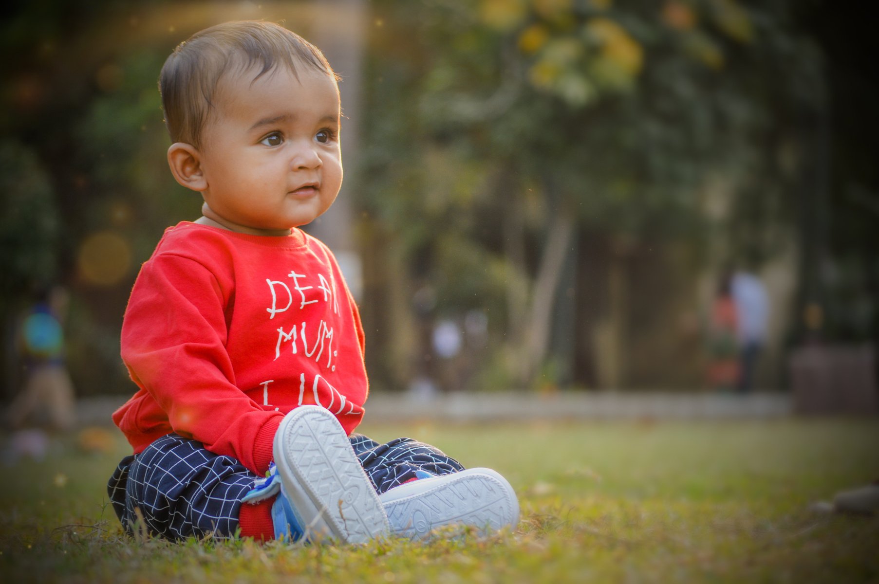 A Toddler Sitting on Grass